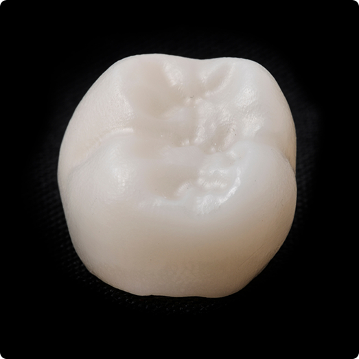 Close up of a dental crown on black background