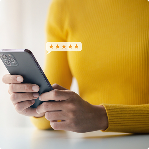 Woman in yellow shirt using phone to leave five star review